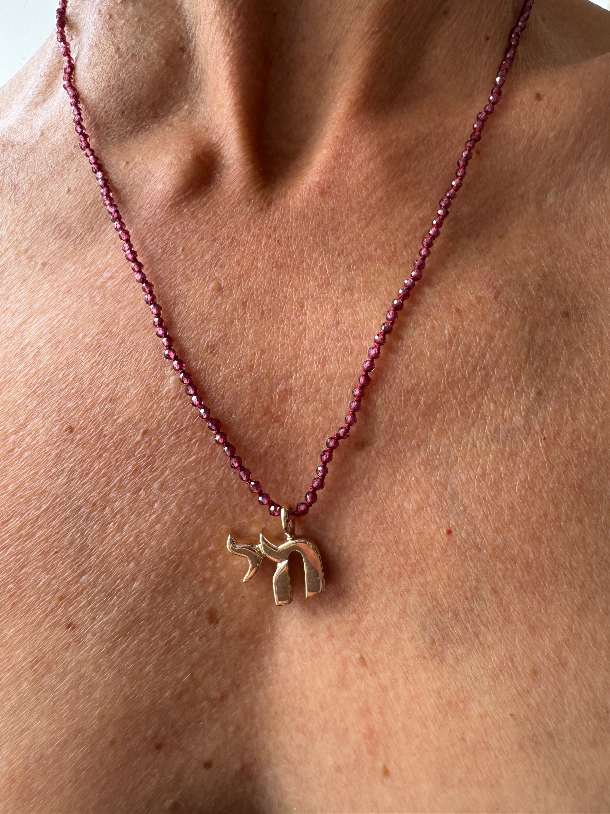 Small Bronze Chai Pendant With Garnet Beads